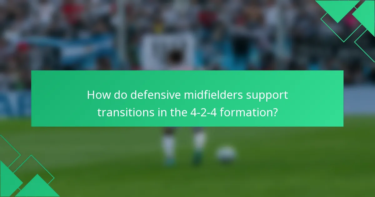 How do defensive midfielders support transitions in the 4-2-4 formation?